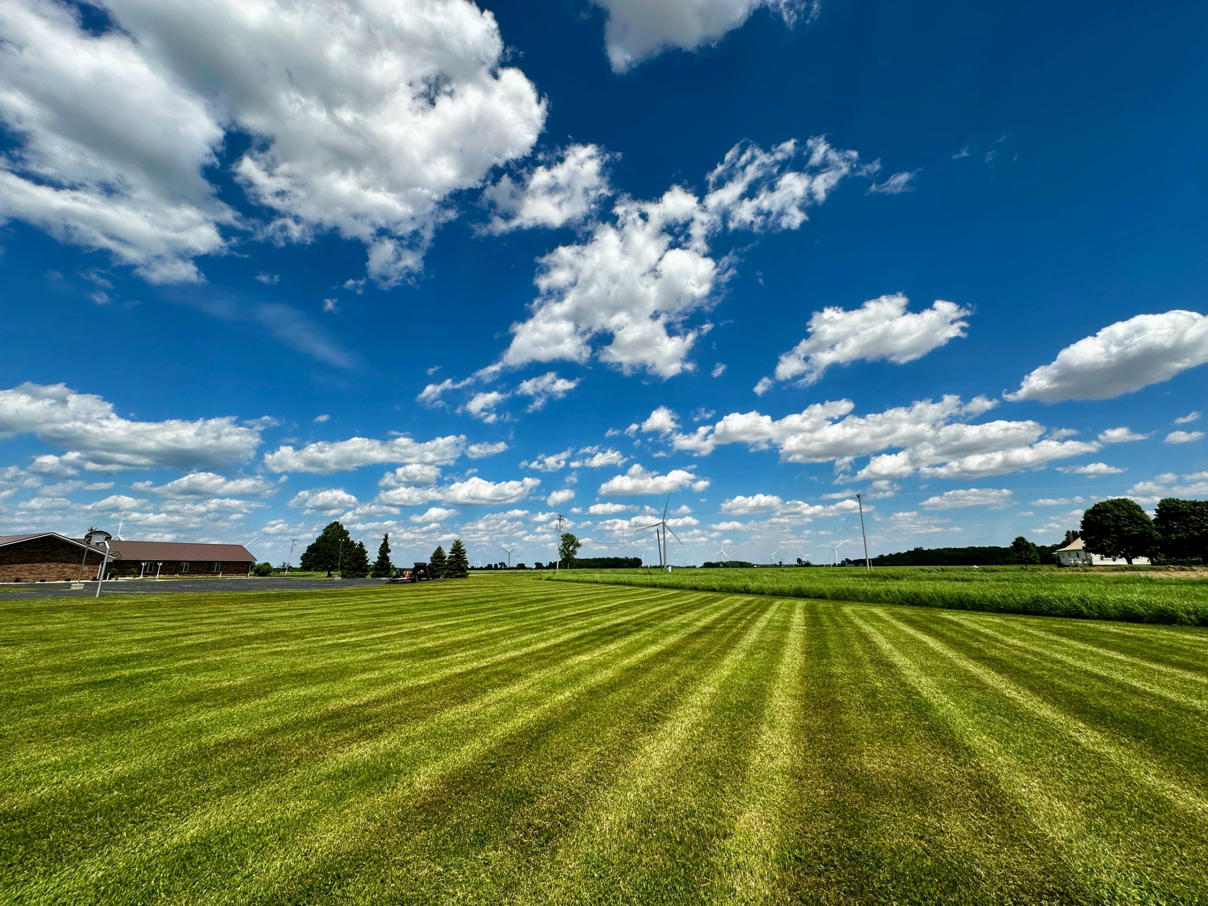 A wide open field freshly cut under a blue Michigan sky